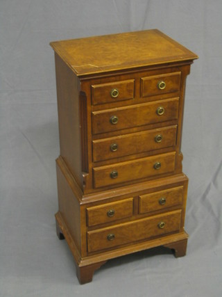 A reproduction Georgian miniature walnut chest on chest with canted corners, fitted 2 short and 3 long drawers, the base fitted 2 short and 1 long drawer, raised on bracket feet 15"
