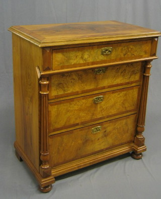 A Continental figured walnut chest with crossbanded top and 4 long graduated drawers, flanked by a pair of fluted columns, the upper drawer fitted compartments 35"
