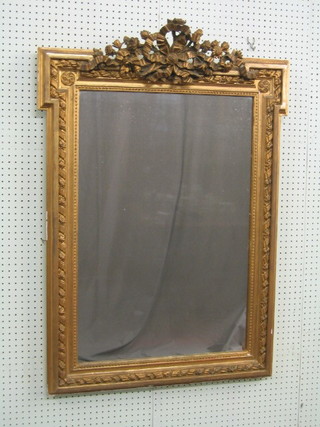A 19th Century rectangular plate mirror contained in a decorative gilt plaster and carved wood frame 45"