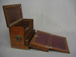 An Edwardian walnut stationery box with hinged lid, the interior fitted a stepped stationery rack, flanked by 3 short drawers incorporating a writing slope with 2 cut glass inkwells and brass handles to the side 17"