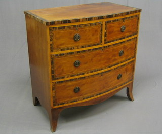 A handsome Georgian mahogany bow front chest of 2 short and 2 long drawers with replacement octagonal plate drop handles, with satinwood stringing and Zebra wood crossbanding (missing 2 escutcheons), raised on splayed bracket feet 35"