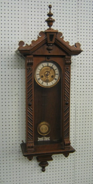 A 19th Century Austrian style striking regulator, the 6" dial with Roman numerals and having a grid iron pendulum, contained in a walnut case