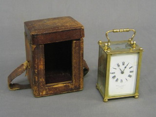 A 19th Century 8 day carriage clock by Mappin & Webb with porcelain dial (somewhat damaged) contained in a gilt metal case complete with leather carrying case