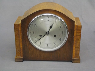 A 1930's 8 day striking mantel clock contained in an oak arch shaped case by Enfield