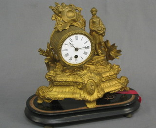 A 19th Century French 8 day mantel clock with drum movement and enamelled dial contained in a gilt painted spelter case decorated a female figure