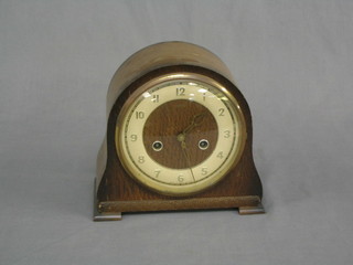 A 1930's 8 day striking mantel clock with Arabic numerals contained in an arched oak case