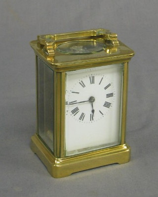 A 19th Century carriage clock with enamelled dial and Roman numerals contained in a gilt metal case