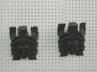 A pair of Eastern carved hard wood wall masks