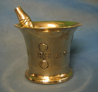A handsome Charles II polished bell metal mortar and pestle, the mortar with crowned Tudor Rose, fleur de lis, crowned thistle, marked CR dated 1641, 7 1/2"
