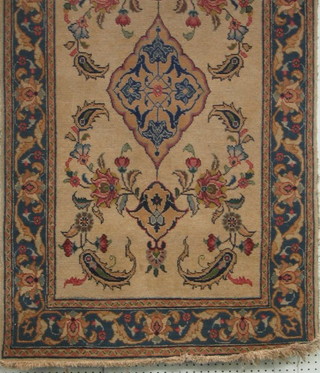 A fine quality old white ground Persian rug with central medallion within blue and floral borders (slight stain to corner) and having signature to base 55" x 32"