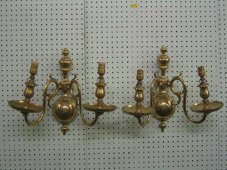 A pair of Dutch style brass twin light wall lights