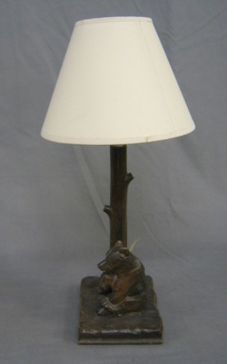 A 1930's carved wooden table lamp in the form of a seated bear by a tree 10"