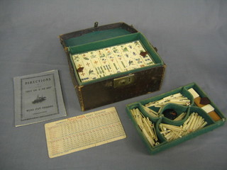 A 1930's ivory and bamboo Mah Jong set complete with markers and instructions, banks and leather carrying case