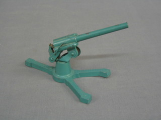 A blue painted tin plate model of an anti-aircraft gun