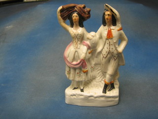 A 19th Century flat back Staffordshire figure group farmer and his wife, 13"