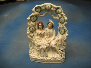 A 19th Century flat back Staffordshire arbour group of seated Scotsman and lady 14"