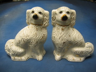 A large and impressive pair of 19th Century Staffordshire figures of seated spaniels with gilt decoration 14"