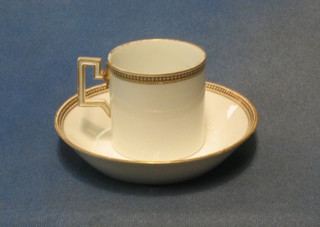 A Meissen coffee can and saucer with gilt banding, the base decorated butterflies
