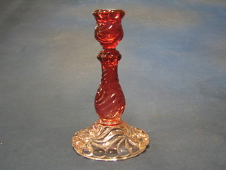 A red pressed glass candlestick, base marked  Baccarat Depote