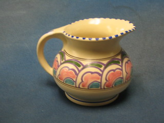 A circular Honiton pottery milk jug with cloud decoration, the base marked Honiton Devon Pottery, 5"