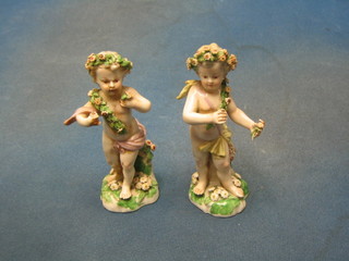 A pair of 19th Century Continental porcelain figures of cherubs (some chips)