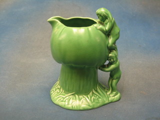 A Sylvac green glazed jug the handle in the form of 2 Pixies, base marked Sylvac 6761 8"