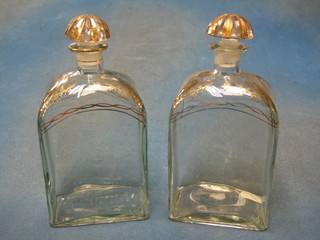 A pair of 20th Century Georgian style decanters and stoppers with gilt banding, the bases marked Liquor Bottle Jerez Spain