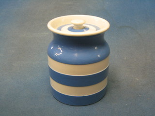 A circular T G Greener blue and white striped Cornish kitchenware storage jar and cover, the base with black shield mark 5"