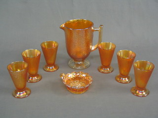 A 7 piece orange Carnival glass crackle glazed lemonade set with jug and 6 beakers and a Carnival glass dish decorated grapes