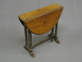 A Victorian walnut oval Sutherland table, raised on bobbin turned supports 22"