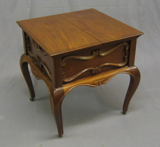 An Edwardian square walnut surprise table with hinged lid, raised on cabriole supports 22"