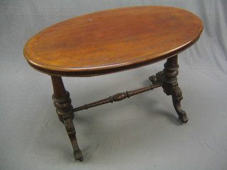 A Victorian oval mahogany stretcher table, raised on turned supports united by an H framed stretcher 40"