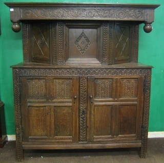 A 17th/18th Century carved oak court cupboard, the upper section fitted cupboards, the base fitted double cupboard enclosed by panelled doors with arcaded decoration  64"
