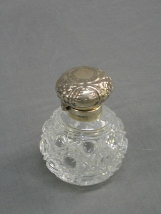 A modern cut glass globular scent bottle with embossed silver lid,