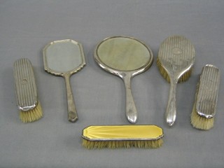 A yellow enamelled and silver backed hand mirror, clothes brush (f) and a silver backed 4 piece dressing table set