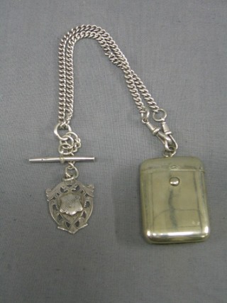 A silver curb link watch chain 14" hung a silver medallion and a silver plated vesta case