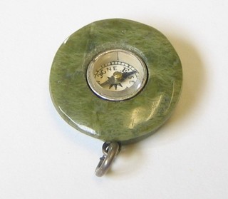 A green hardstone charm in the form of a cap set a compass