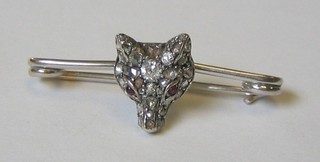 A bar brooch in the form of a foxes mask set white and red stones