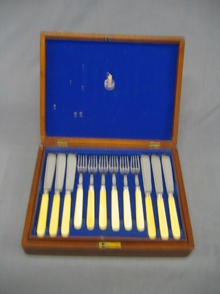 A canteen of 18 silver plated fish knives and forks, in a walnut canteen