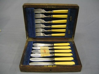 A set of 6 silver plated fish knives and forks in an oak canteen box