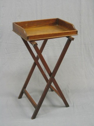 A Victorian mahogany butler's tray raised  on a folding stand 20"