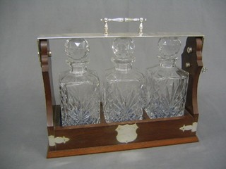 A 20th Century mahogany  3 bottle spirit tantalus with silver plated mounts