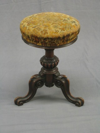 A Victorian carved walnut revolving adjustable piano stool raised on a turned column and tripod supports (with old crude repair)
