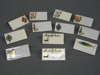 A set of 12 gilt metal and porcelain table place setting names