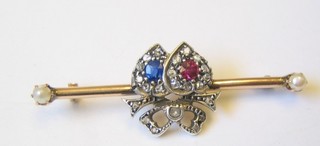A lady's gold bar brooch in the form of 2 entwined hearts set rubies, sapphires, diamonds and pearls