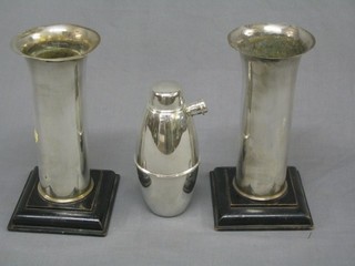 A pair of Art Deco style silver plated vases, raised on ebony feet 10" and an Art Deco silver plated cocktail shaker