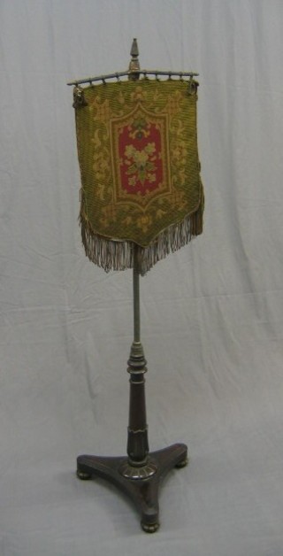 A William IV rosewood and brass pole screen with Berlin wool work banner