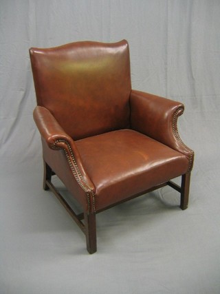 A 19th Century mahogany framed armchair upholstered in brown leatherette