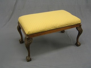 A rectangular Queen Anne style stool, raised on carved cabriole ball and claw supports