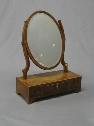 A 19th Century oval bevelled plate dressing table mirror contained in a mahogany swing frame, the base fitted 1 long and 2 short drawers and raised on bracket feet 15"